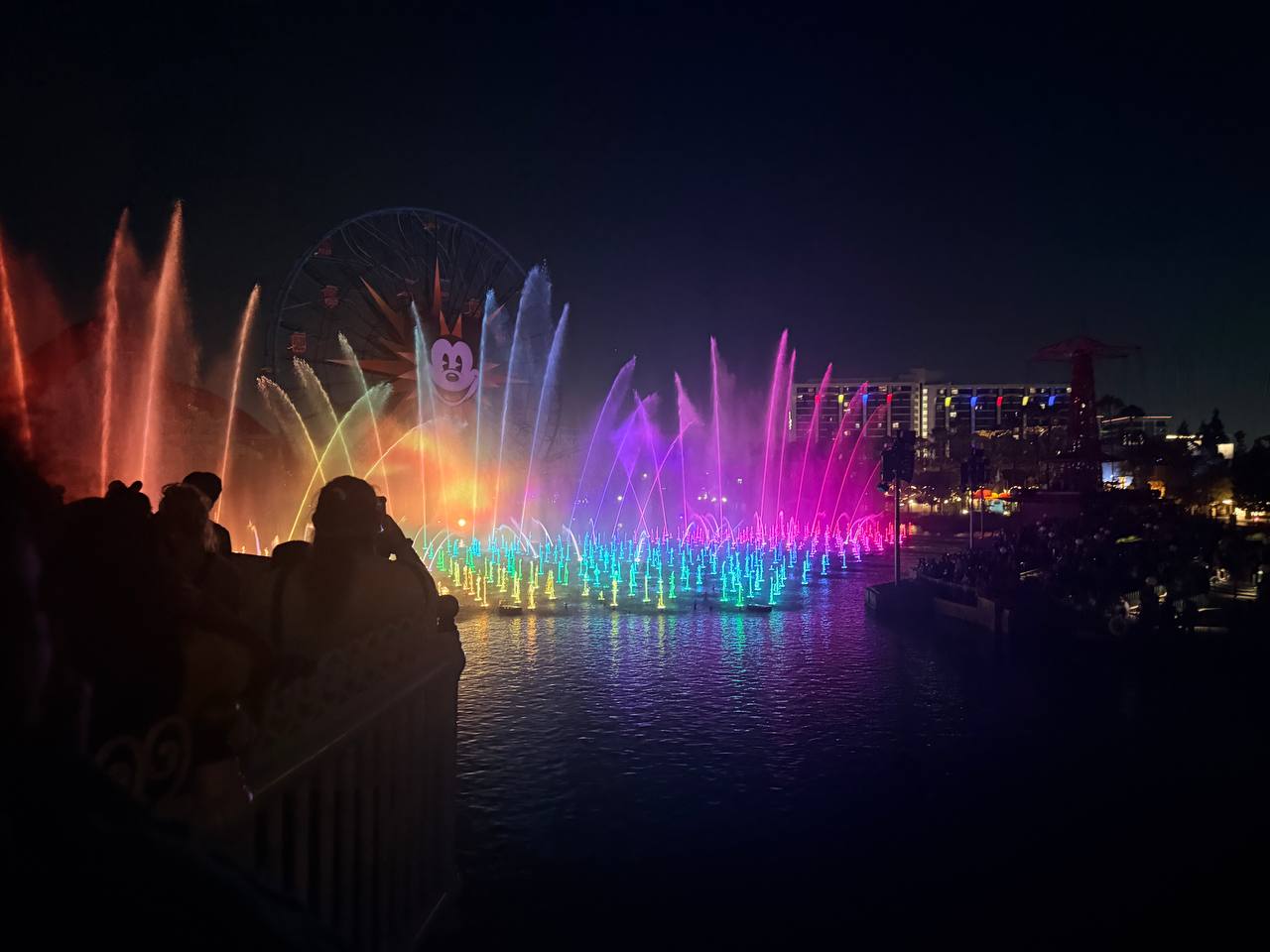 Nighttime Disney water and light show with colorful fountains